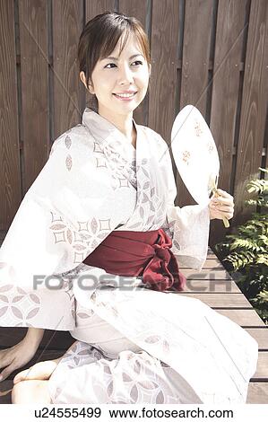 Japanese woman putting on kimono View Large Photo Image Stock Photo - Japanese woman putting on kimono. Fotosearch