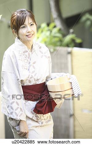 Japanese woman putting on kimono View Large Photo Image Stock Photography - Japanese woman putting on kimono. Fotosearch