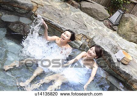 Stock Image - Japanese women in a open-air bath. Fotosearch