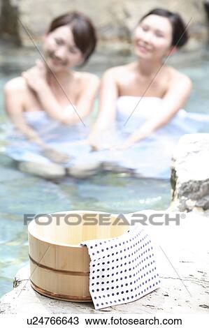 Stock Image - Japanese women in a open-air bath. Fotosearch