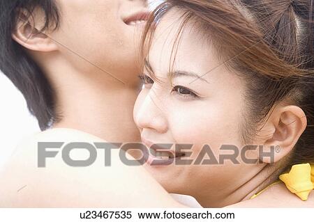 Stock Photography - Japanese couple hugging each other. Fotosearch