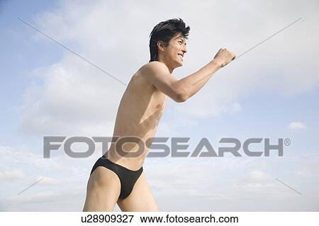 Stock Photo - Japanese man in swimsuit. Fotosearch