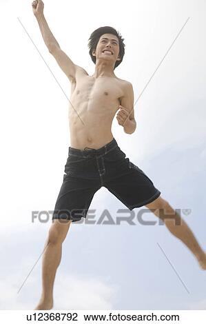Stock Image - Japanese man jumping. Fotosearch