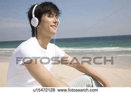 Japanese man listening to music View Large Photo Image Stock Photo - Japanese man listening to music. Fotosearch