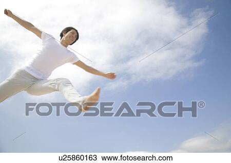 Stock Image - Jumping Japanese man. Fotosearch
