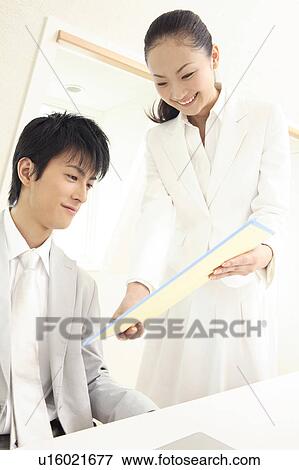 Stock Photo - Office lady handing a document. Fotosearch