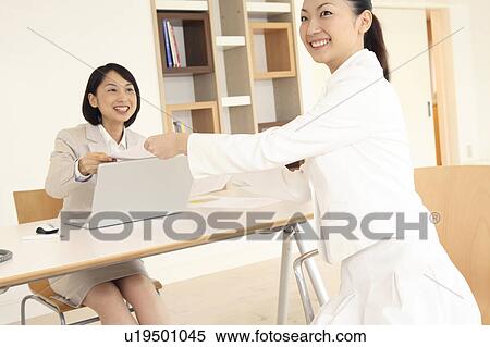 Office lady handing a document View Large Photo Image Stock Photography - Office lady handing a document. Fotosearch