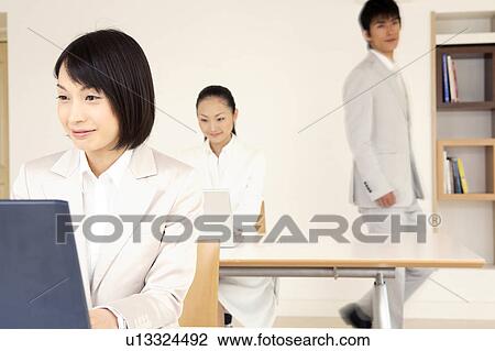 Stock Image - Office lady operating a PC. Fotosearch