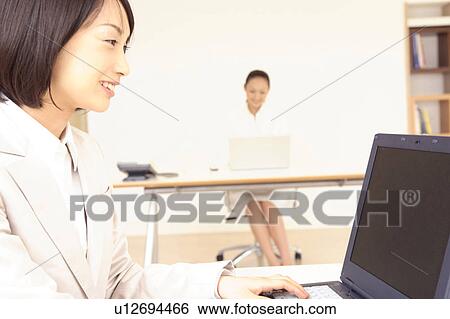 Office lady operating a PC View Large Photo Image Stock Photograph - Office lady operating a PC. Fotosearch