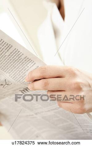 Stock Photography - Office lady reading a newspaper. Fotosearch