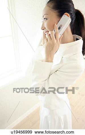 Stock Photo - Office lady talking with cell phone. Fotosearch