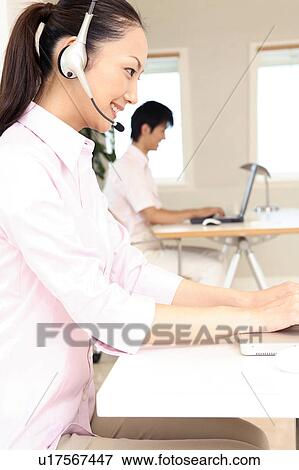 Office lady talking with headset View Large Photo Image Stock Photo - Office lady talking with headset. Fotosearch