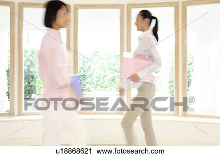 Office lady walking in a room View Large Photo Image Stock Image - Office lady walking in a room. Fotosearch