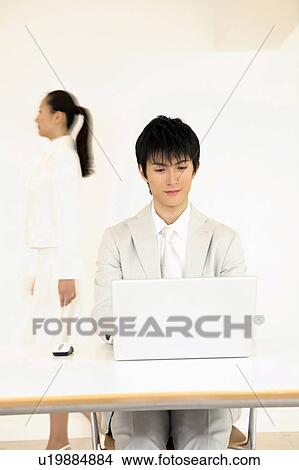 Office worker operating a PC View Large Photo Image Picture - Office worker operating a PC. Fotosearch