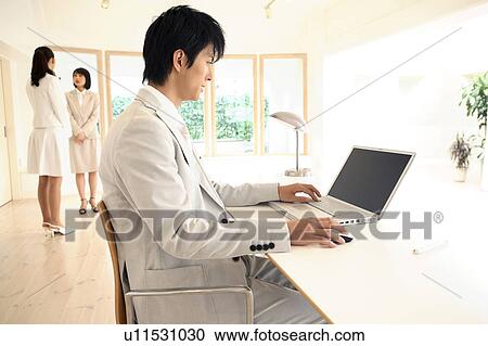 Stock Image - Office worker operating a PC. Fotosearch