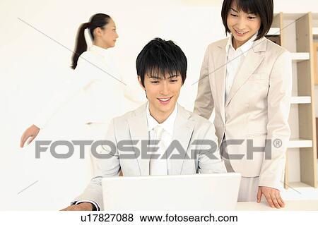 Stock Photo - Office worker operating a PC. Fotosearch