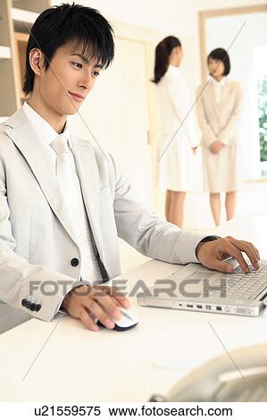 Office worker operating a PC View Large Photo Image Stock Photography - Office worker operating a PC. Fotosearch