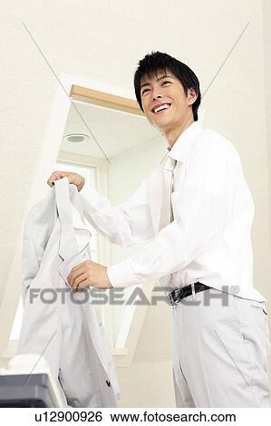 Office worker taking off a jacket View Large Photo Image Stock Photograph - Office worker taking off a jacket. Fotosearch
