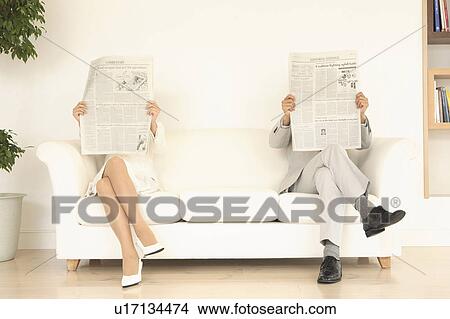 Office workers reading a newspaper View Large Photo Image Picture - Office workers reading a newspaper. Fotosearch