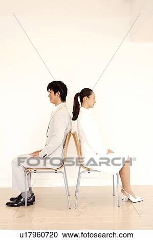 Office workers sitting on a chair View Large Photo Image Stock Image - Office workers sitting on a chair. Fotosearch