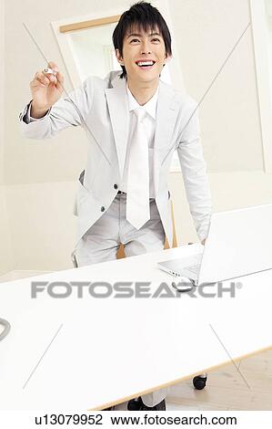 Smiling Japanese office worker View Large Photo Image Stock Image - Smiling Japanese office worker. Fotosearch