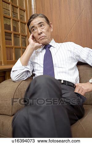 Japanese CEO relaxed on the sofa View Large Photo Image Stock Image - Japanese CEO relaxed on the sofa. Fotosearch