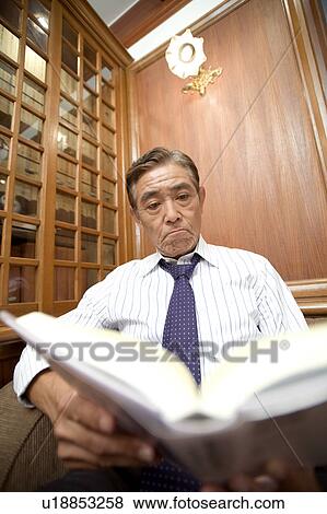 Japanese executive reading a book View Large Photo Image Stock Photo - Japanese executive reading a book. Fotosearch