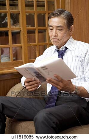 Stock Photography - Japanese executive reading a book. Fotosearch