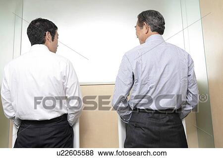 Stock Photo - Japanese office worker doing pee. Fotosearch