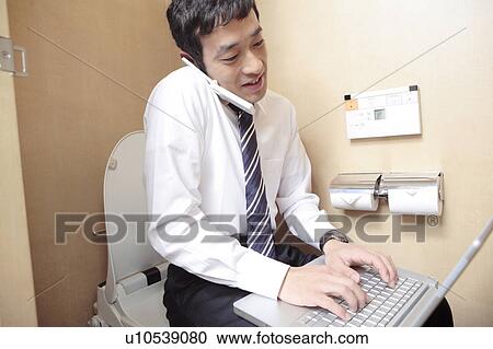 Japanese office worker operating a PC in a rest room View Large Photo Image Stock Image - Japanese office worker operating a PC in a rest room. Fotosearch