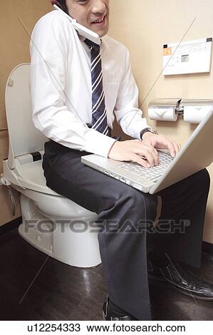 Japanese office worker operating a PC in a rest room View Large Photo Image Stock Image - Japanese office worker operating a PC in a rest room. Fotosearch