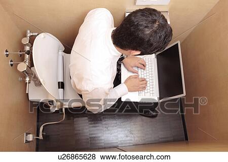 Japanese office worker operating a PC in a rest room View Large Photo Image Stock Photo - Japanese office worker operating a PC in a rest room. Fotosearch