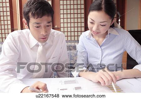 Stock Photo - Office workers having a meeting. Fotosearch