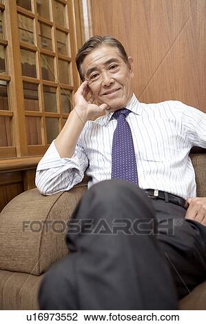 Stock Image - Smiling Japanese executive. Fotosearch