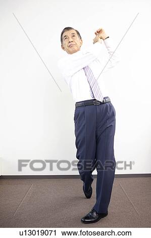 Chief executive officer checking golf swing View Large Photo Image Stock Image - Chief executive officer checking golf swing. Fotosearch