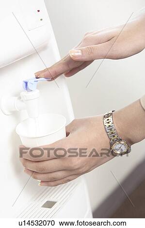 Stock Image - Hand of a woman serving water. Fotosearch