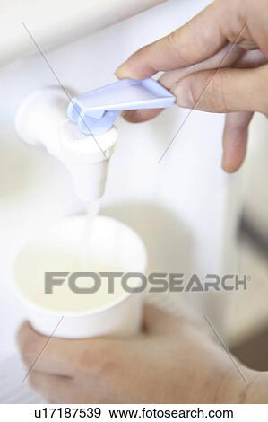 Stock Photo - Hand of a woman serving water. Fotosearch