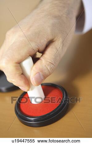 Stock Photography - Hand of chief executive officer pushing the stamp. Fotosearch