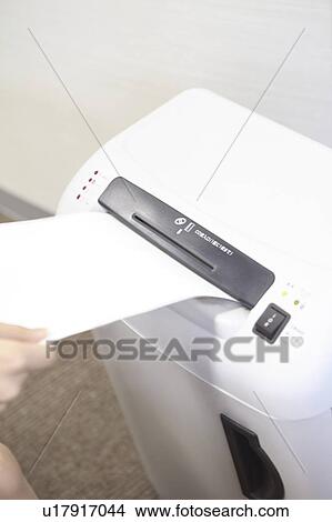 Picture - Hand of Japanese office lady doing a shredder. Fotosearch
