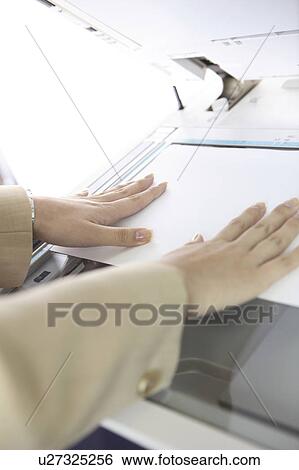 Hand of Japanese office lady taking a copy View Large Photo Image Stock Photograph - Hand of Japanese office lady taking a copy. Fotosearch