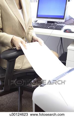 Stock Image - Japanese office lady doing a shredder. Fotosearch