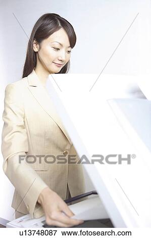 Japanese Office Lady Taking A Copy Stock Photo U Fotosearch