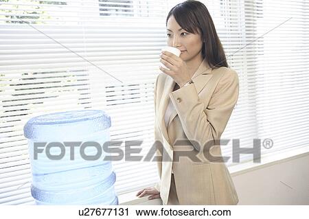 Office lady drinking a water View Large Photo Image Stock Image - Office lady drinking a water. Fotosearch