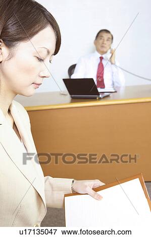 Secretary checking a notebook View Large Photo Image Stock Photo - Secretary checking a notebook. Fotosearch