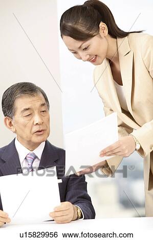 Stock Photograph - Secretary explaining about a report. Fotosearch