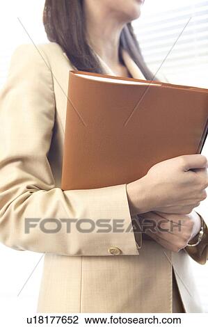 Stock Image - Secretary holding a file. Fotosearch