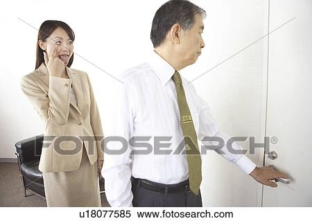 Secretary making faces at president View Large Photo Image Stock Photography - Secretary making faces at president. Fotosearch