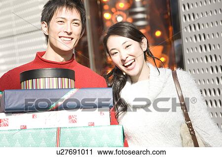 Stock Image - Japanese young couple enjoy shopping. Fotosearch