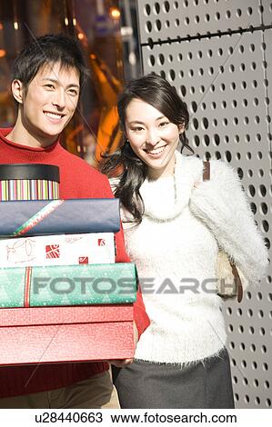 Stock Image - Japanese young couple enjoy shopping. Fotosearch