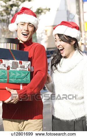 Stock Photo - Japanese young couple enjoy shopping. Fotosearch